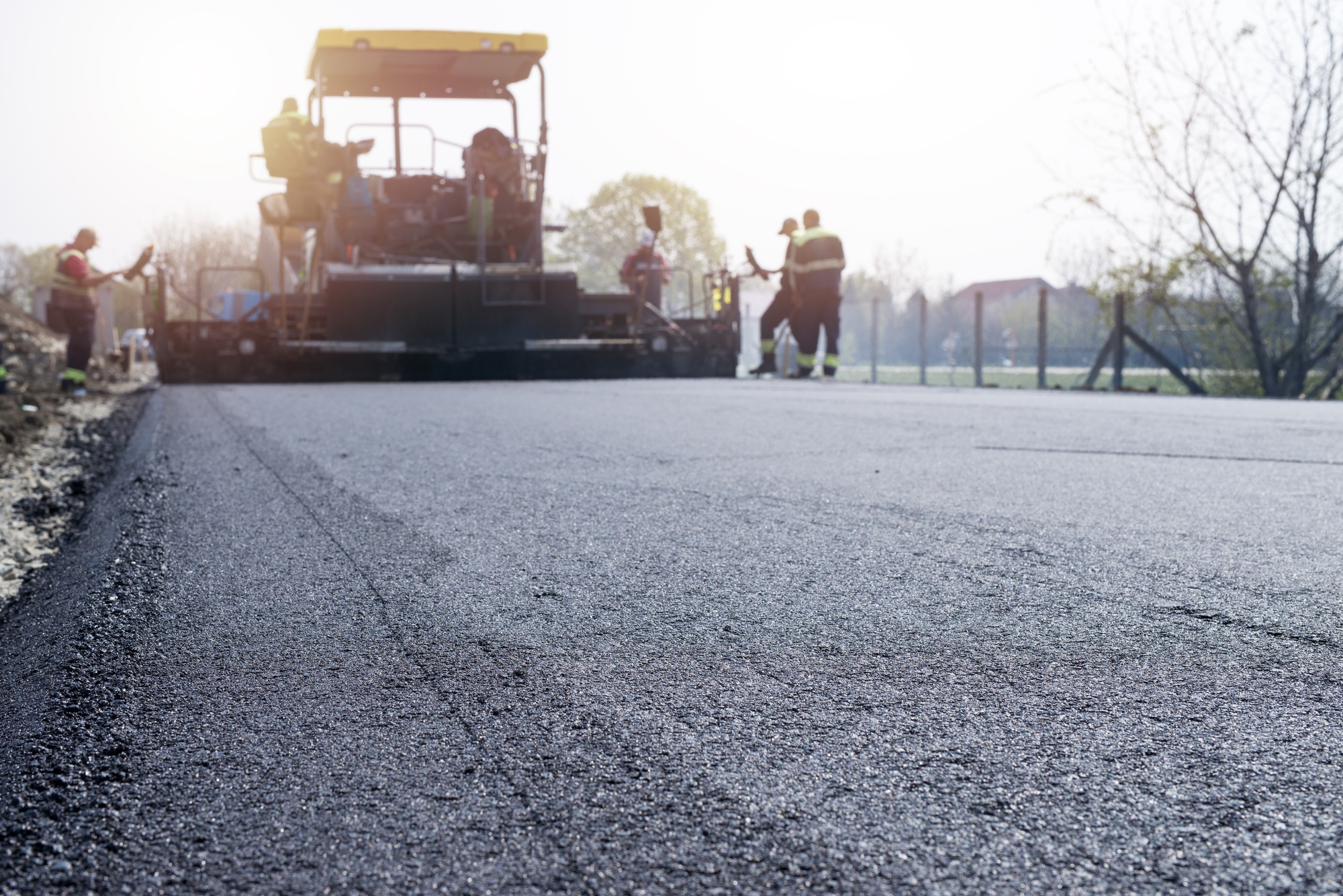 workers-placing-new-coating-asphalt-road